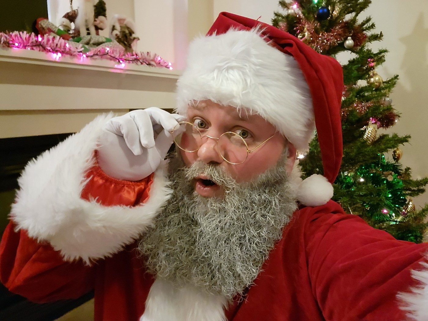 Stefan as Santa beside a Christmas tree